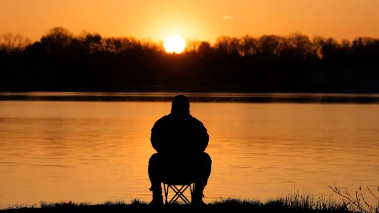 Serene sunrise meditation scene representing spiritual healing and the removal of spiritual blockages
