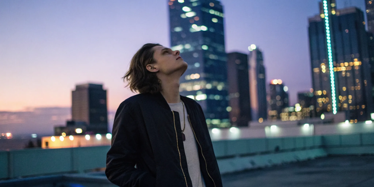 Person on a rooftop at dusk wondering why they're still anxious after so much spiritual work.