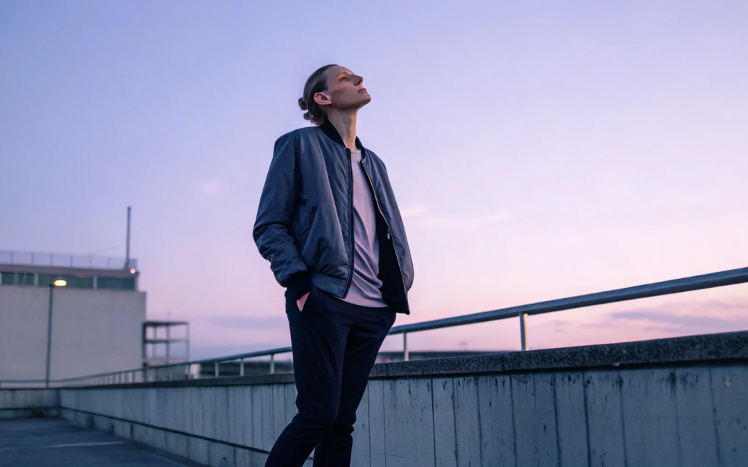 A person on a rooftop at sunset, reflecting on how to stop feeling guilty.