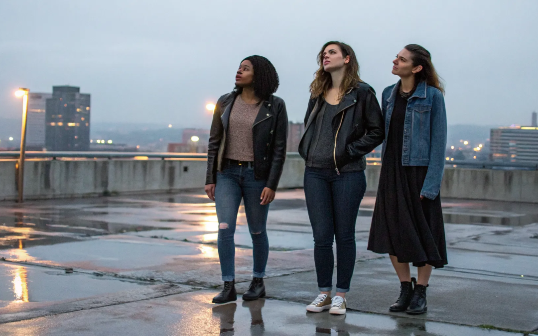 Three women on a rooftop finding community and support after leaving the Catholic Church.