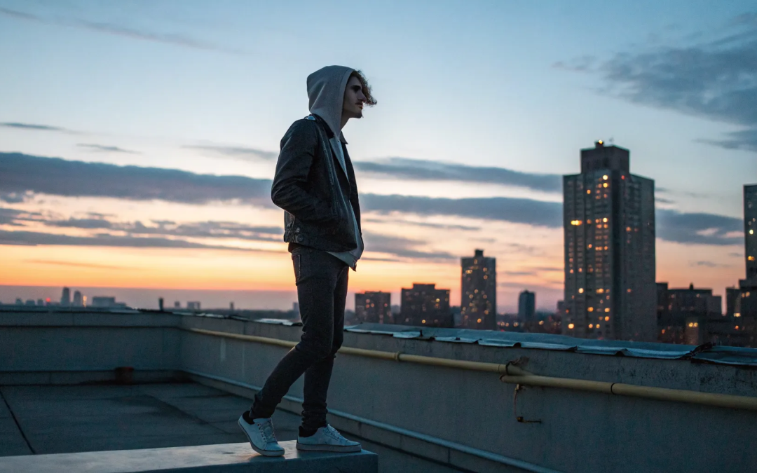 Person on a rooftop at sunset, healing the fear of hell after leaving Catholicism.