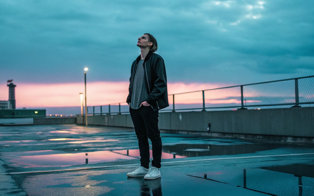 A person alone on a rooftop at sunset, feeling the spiritual disconnection from God.