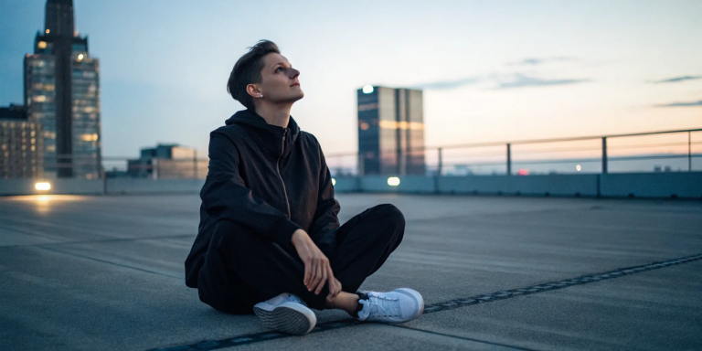 Person meditating at sunset to practice chakra healing for blockages.